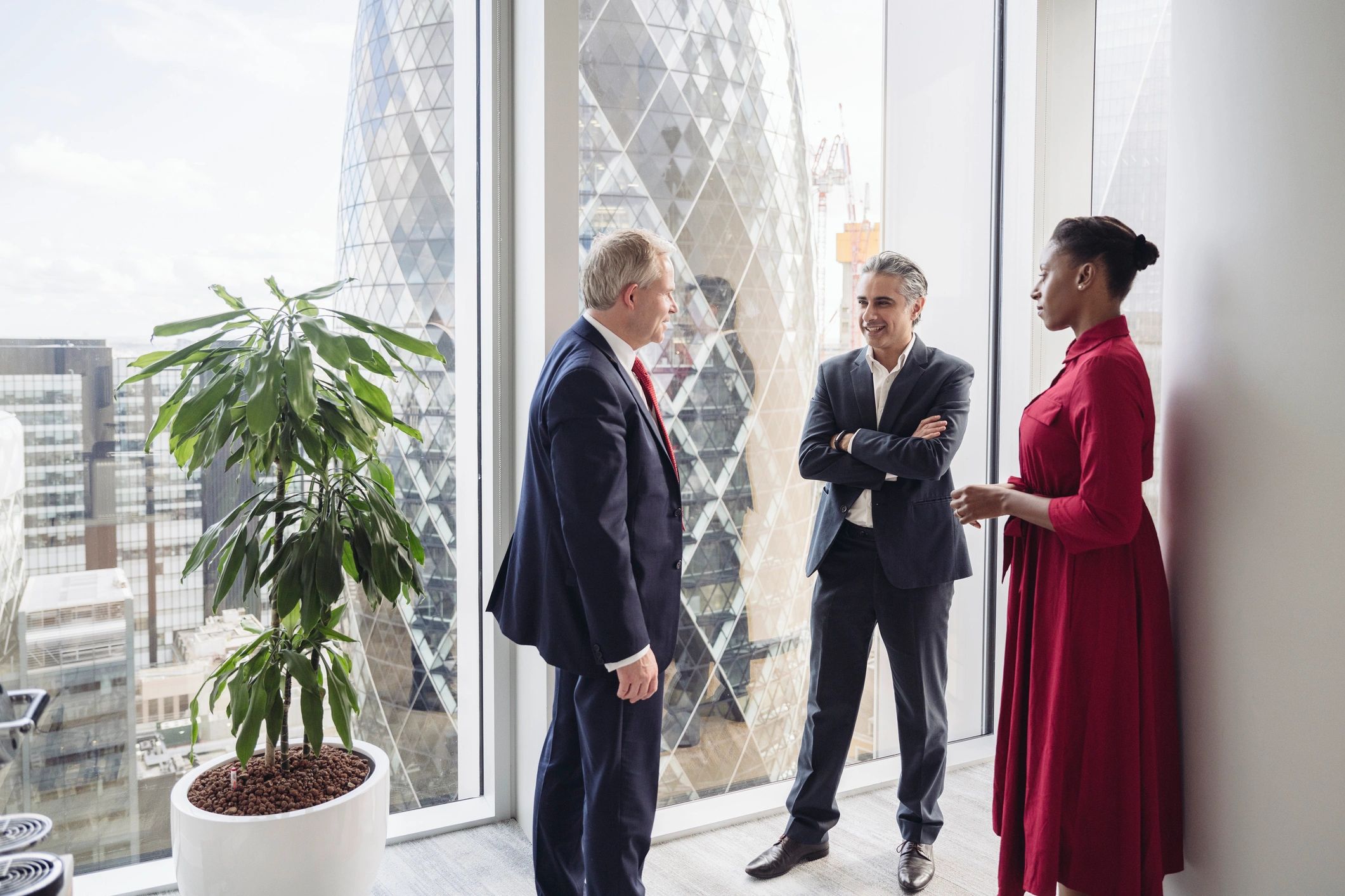 Business team standing and talking in a modern London office